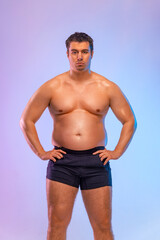 Fototapeta na wymiar A very fat man want to lose weight and become a slim athlete. Fitness concept.
