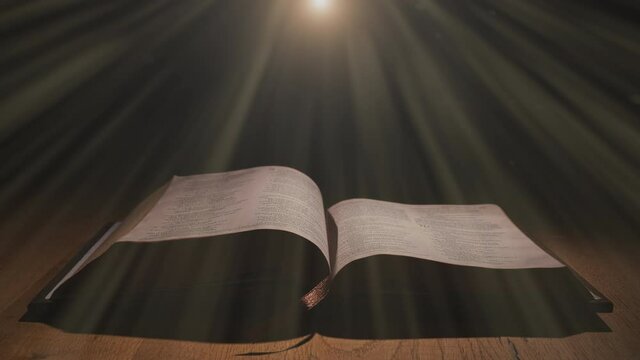 Light-rays shining down on a open bible