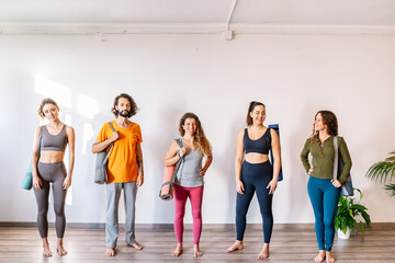 Fototapeta premium Man and women talking after yoga lesson
