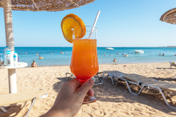 Iced mocktails glass on the beach. Cocktail on beach.