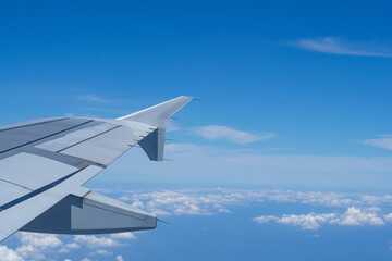 Obraz premium Aerial view of clouds and sky seen through the airplane window