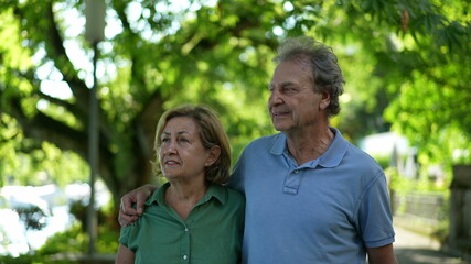 Happy senior couple walking together in afternoon walk