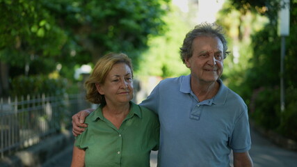 Happy senior couple walking together in afternoon walk