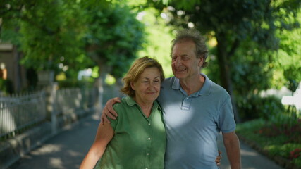 Fototapeta premium Happy senior couple walking together in afternoon walk