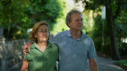 Happy senior couple walking together in afternoon walk