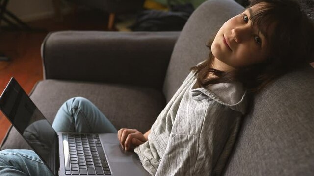 indoor portrait of pre-teen girl doing homework online or browsing internet, mdeia technologies, digital communication or shopping, teenager lifestyle. 