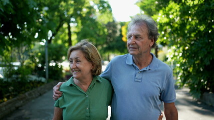 Happy senior couple walking together in afternoon walk