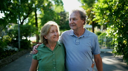 Happy senior couple walking together in afternoon walk