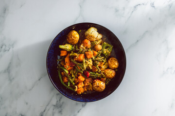 vegan mixed vegetable roast with gravy sauce, healthy plant-based food