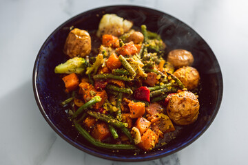 vegan mixed vegetable roast with gravy sauce, healthy plant-based food