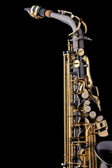 A black saxophone with gold plated keys on a black background