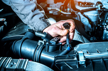 Mass air flow sensor checking close up. Car diagnostics in auto service.