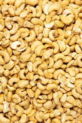 Peeled fresh golden cashew nuts in bulk top view