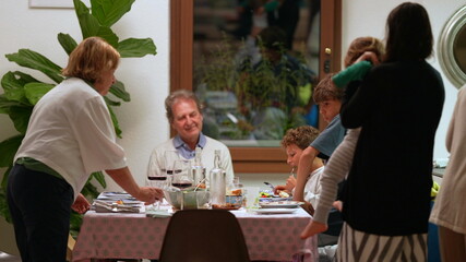 Family together at table home, candid people family reunion for holidays