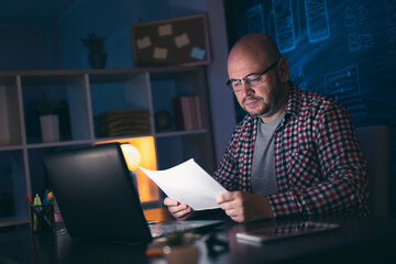 Man doing paperwork late at night