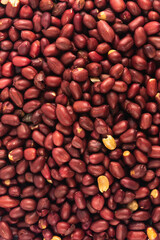 Peeled fresh golden peanuts nuts close up in bulk top view