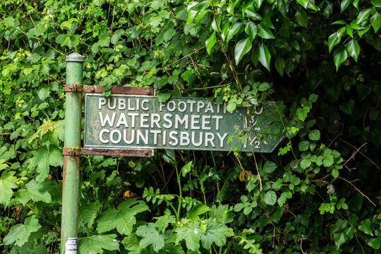 public footpath sign for watersmeet and countisbury green sign surrounded with vegetation tourism uk England Devon