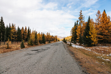 A road in the mountains with beautiful landscapes and views of rocks and peaks in Altai