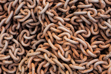 close up macro of a old rusty pile of metal industrial chain