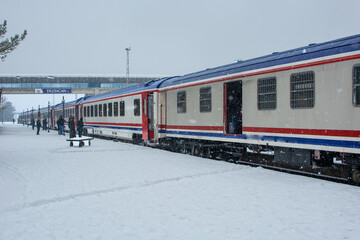 it's snowing, train and passengers.