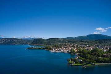Naklejka na ściany i meble Aerial view of Bardolino, Lake Garda, Italy. Panorama of the historic town of Bardolino. Top view of the historic part of the city of Bardolino on the coastline of Lake Garda.