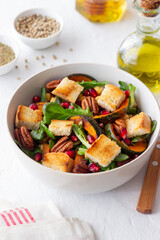 Salad with pumpkin, pomegranate, pecans and croutons. Healthy eating. Vegetarian food.