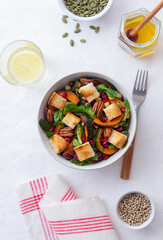 Salad with pumpkin, pomegranate, pecans and croutons. Healthy eating. Vegetarian food.