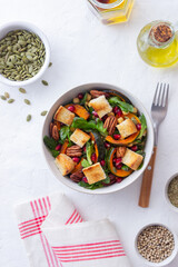 Salad with pumpkin, pomegranate, pecans and croutons. Healthy eating. Vegetarian food.