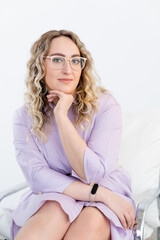 Portrait of plus sized lady with glasses in purple dress