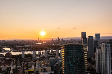 Panoramic aerial skyline view of east London at sunrise with skyscrapers of Canary Wharf and beautiful colorful sky at background