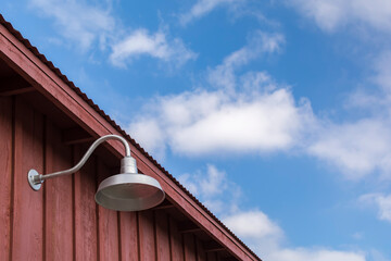 Gooseneck light on wood barn wall