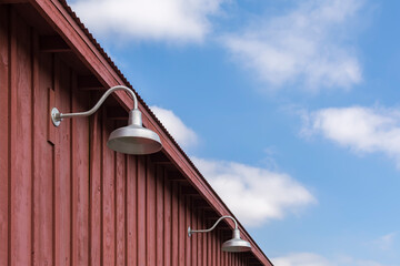 Gooseneck lights on wood barn wall