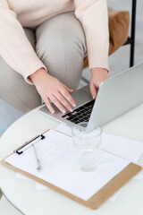 Close-up of women's hands typing using a laptop. The concept of online learning. The work of a...