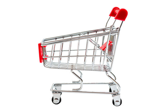 Supermarket grocery shopping, checkout purchase and carrying groceries concept with push shopping cart and no people isolated on white background with clipping path cutout