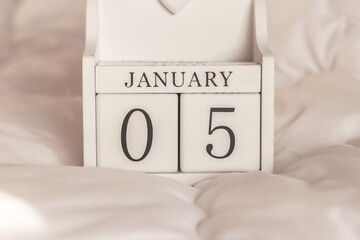 January 5th.  Day 5 of month, date calendar on winter background.  White block calendar present date 5 and month January, winter time, birthdays, special occasions, website events.
