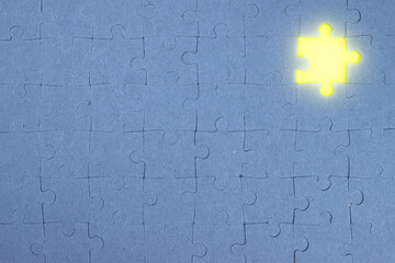 Missing puzzle piece with yellow light light, business concept of completing a task, achieving a...