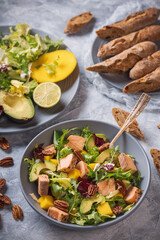 Baked salmon, mango and avocado salad with pecan nuts.
