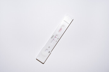 Positive at-home covid self-test on white background. Over-the-counter OTC tests for corona pandemic