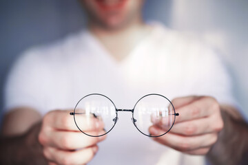 The concept of poor vision. Hold a contact lens and glasses in hand. A poster for advertising...