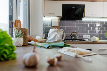 Cotton reusable produce bag with food on the table in the kitchen
