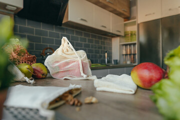 Cotton reusable produce bag with food on the table in the kitchen