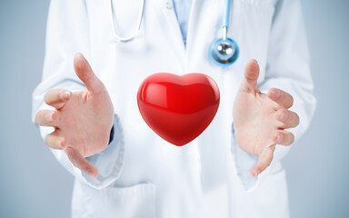 Female doctor hands holding a 3d illustration of red heart.