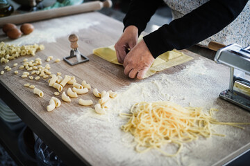 Woman prepare fresh ravioli inside pasta factory