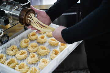 Man working with pasta manufacture machine