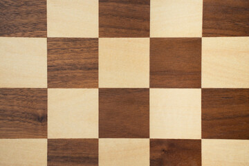 Wooden darl and light chess board background