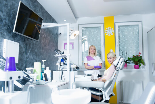 Female dentist and her patient in a dental office