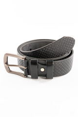 Fastened fashionable men's leather belt with dark matted metal buckle isolated on white background.