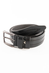 Fastened fashionable men's leather belt with dark matted metal buckle isolated on white background.