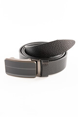 Fastened fashionable men's leather belt with dark matted metal buckle isolated on white background.