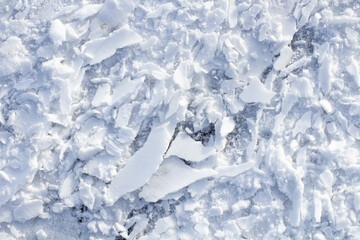 Fototapeta na wymiar Texture of snow chips close up, place for text